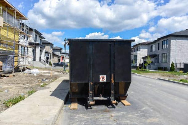Loaded dumpster near a construction site, home renovation in Montreal Bois-franc.