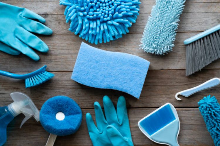 House cleaning product on wood table, blue equipment concept