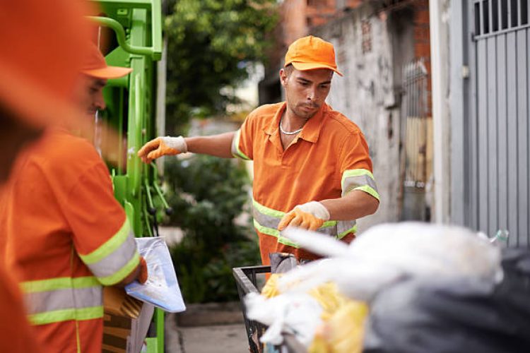 Cropped shot of a garbage collection team at work Cropped shot of a garbage collection team at work
