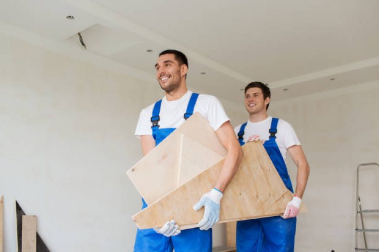building, construction, repair, teamwork and people concept - group of builders with wooden boards