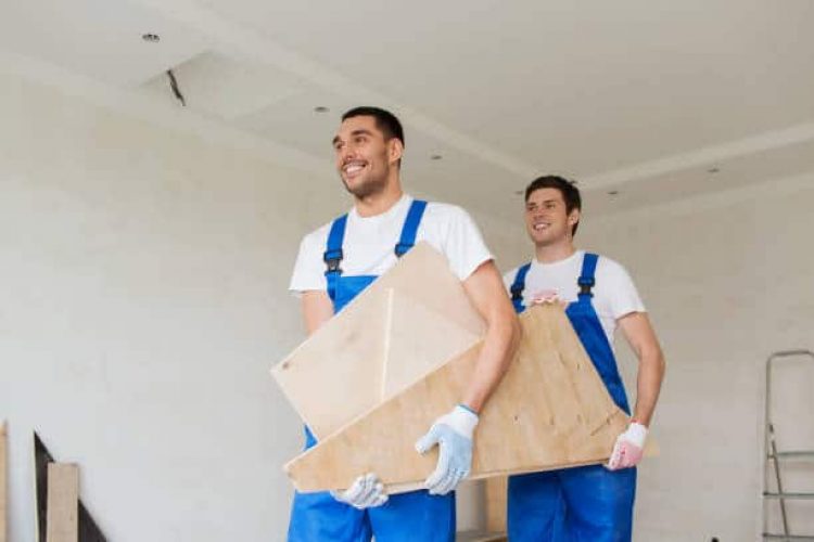 building, construction, repair, teamwork and people concept - group of builders with wooden boards