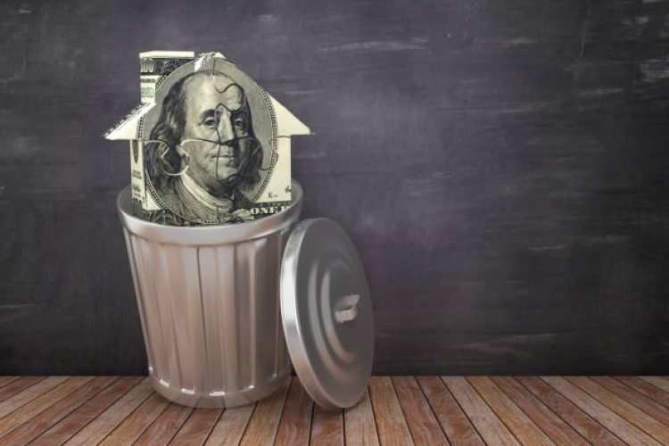 Trash Can with Dollar Puzzle House on Chalkboard Background - 3D Rendering