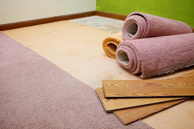 rolls of old carpet showing the layers of the flooring