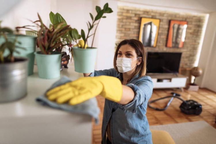 Woman working at home, cleaning the floors, washing the laundry and cleaning up the mess in the closet during quarantine