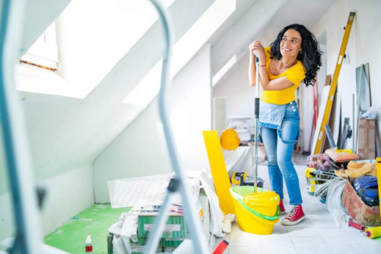 Mid adult woman cleaning up apartment after home