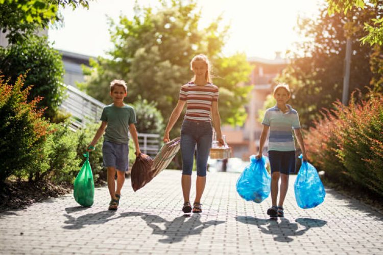 Kids taking out the segregated garbage. The kids are walking in residential area - carrying segregated garbage.
Nikon D850